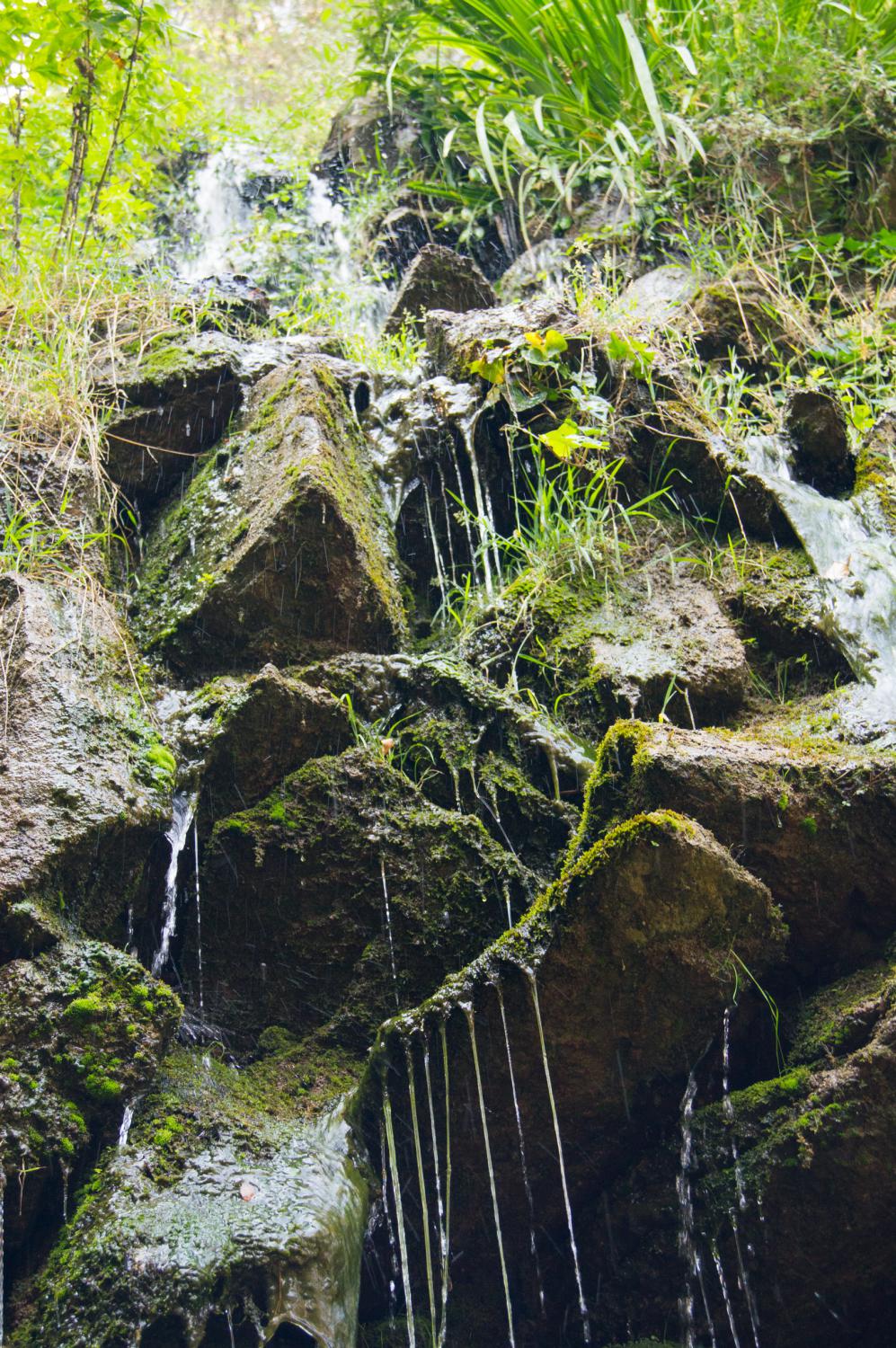 Beautiful and unusual waterfall in the park maze Horta in Barcelona