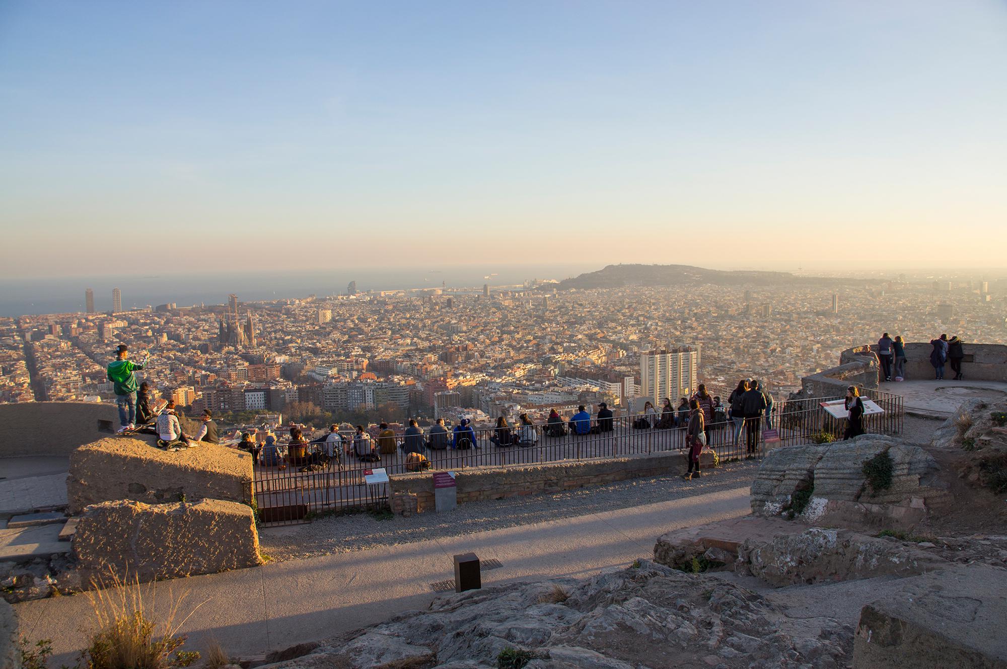 Teens admire the sunset over Barcelona from Bunkers del Carmel