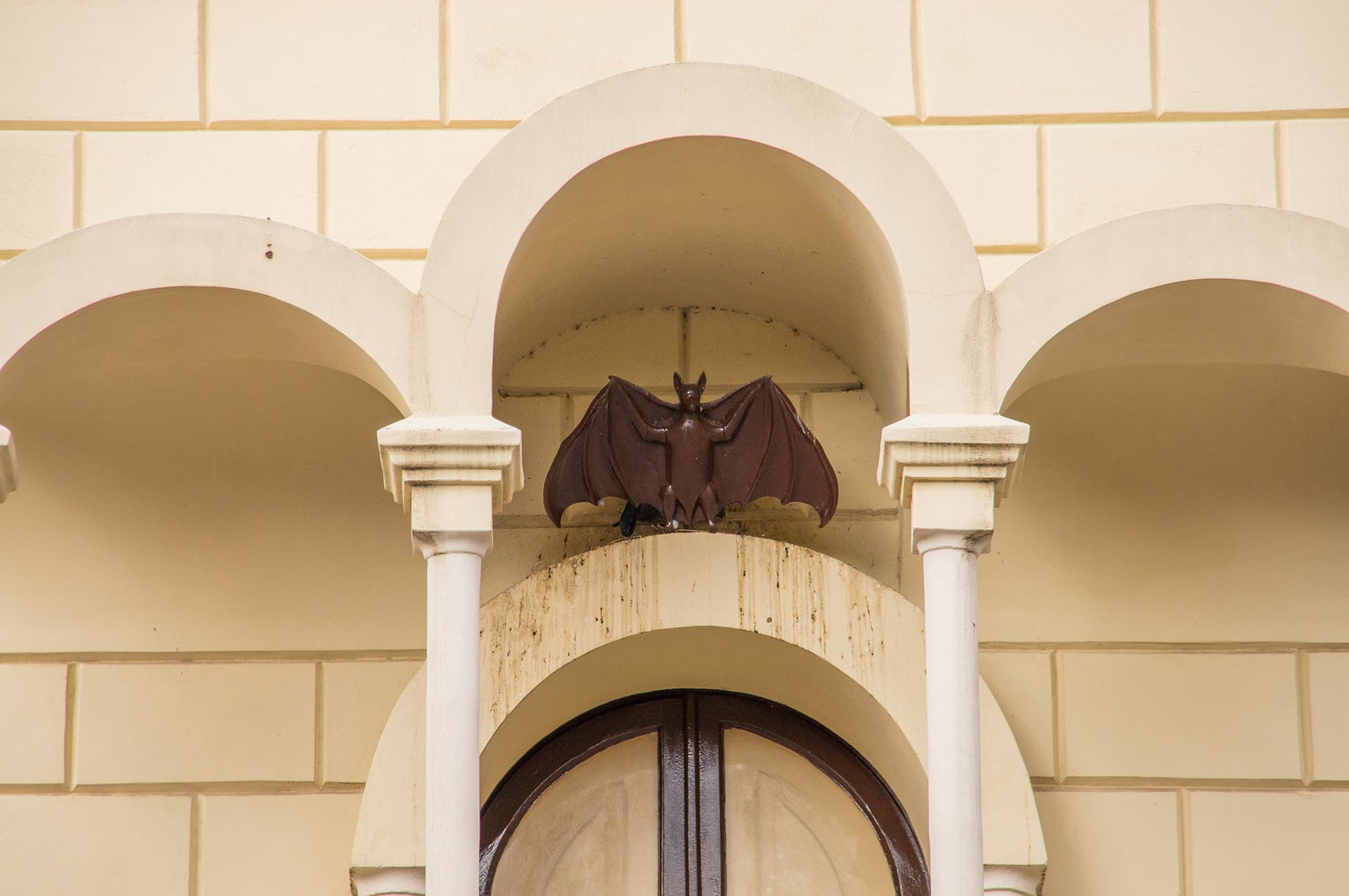 Sculpture of a bat above the door in Colonia Guell in Catalonia