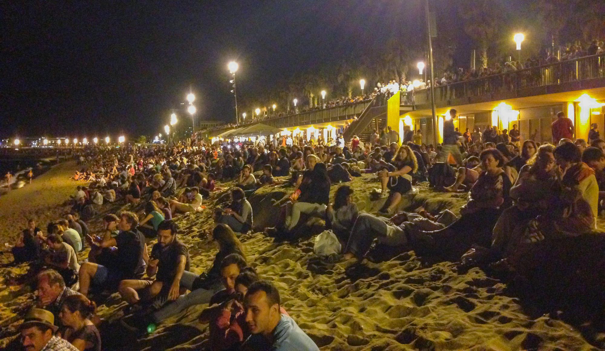 People are waiting for the fireworks on the beach of Barceloneta